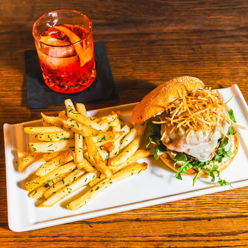 Burger, fries and a cocktail at Louie's Bar